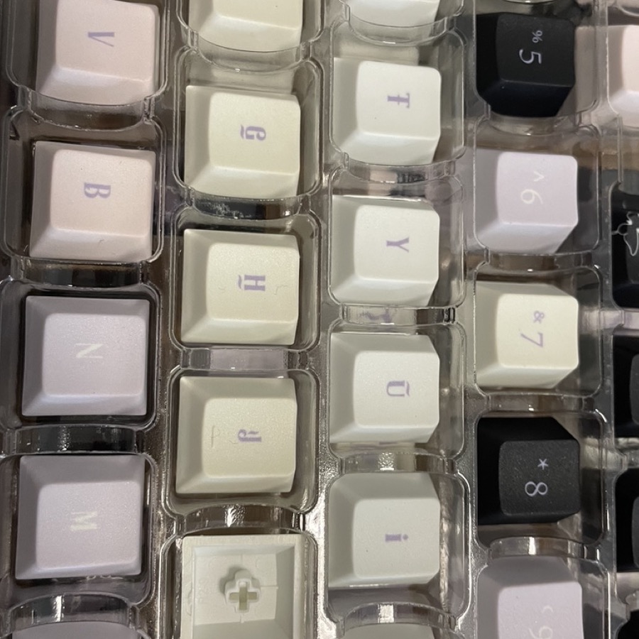 Close-up of lilac butterfly keycaps in tray